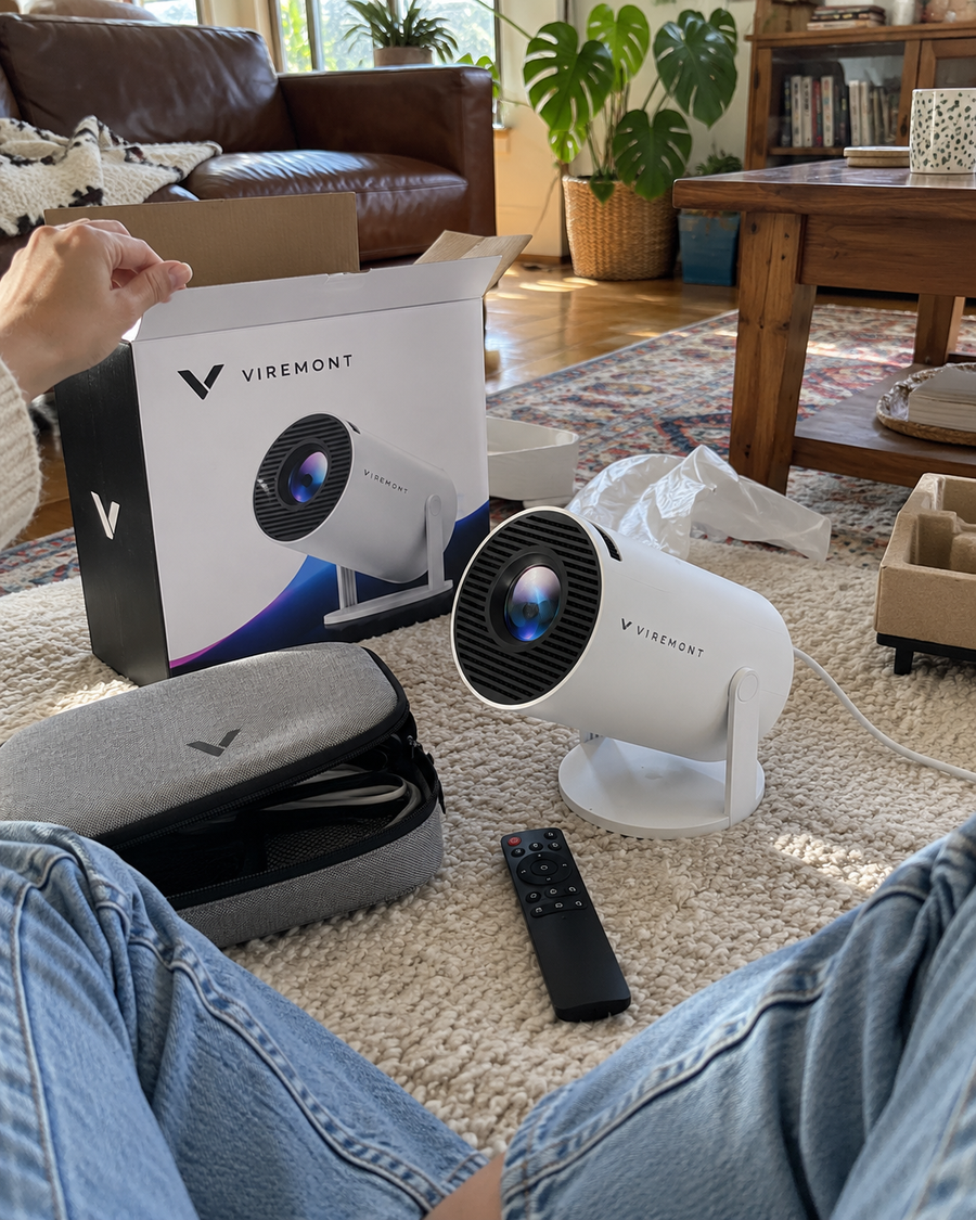 Illustrative Viremont setup: Cylindrical projector on rug with open packaging and carrying case