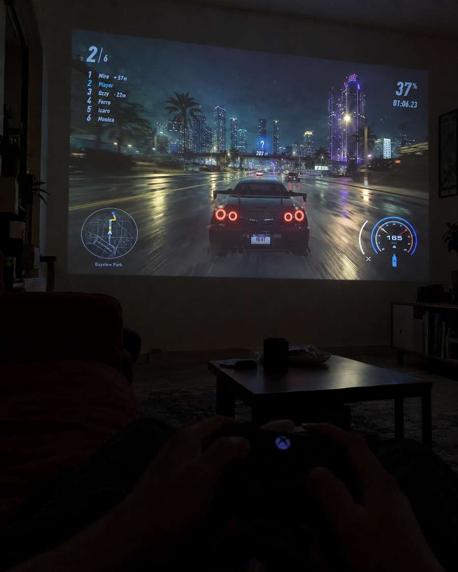 Illustrative Viremont setup: Racing videogame projected in dark living room